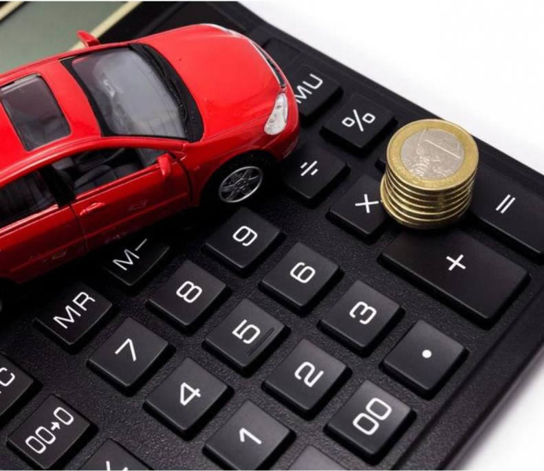car and coins on top of calculator